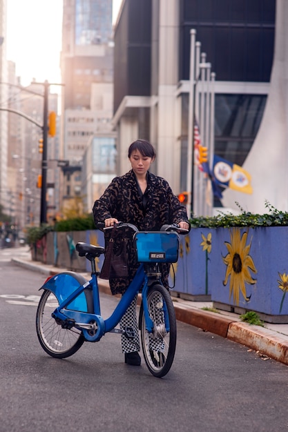 Free photo young adult using bike to travel in the city