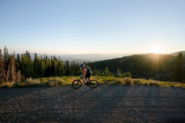 Free photo young adult using electric bike in the country side