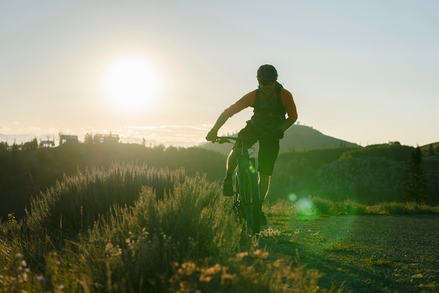 Free photo young adult using electric bike in the country side