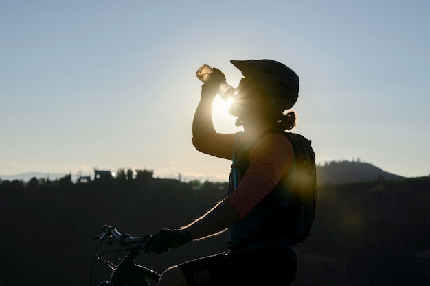 Free photo young adult using electric bike in the country side