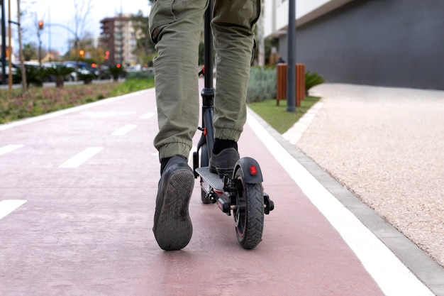 Young adult using electric scooter for transportation