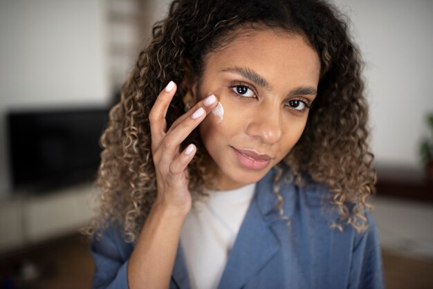 Young adult using face care product