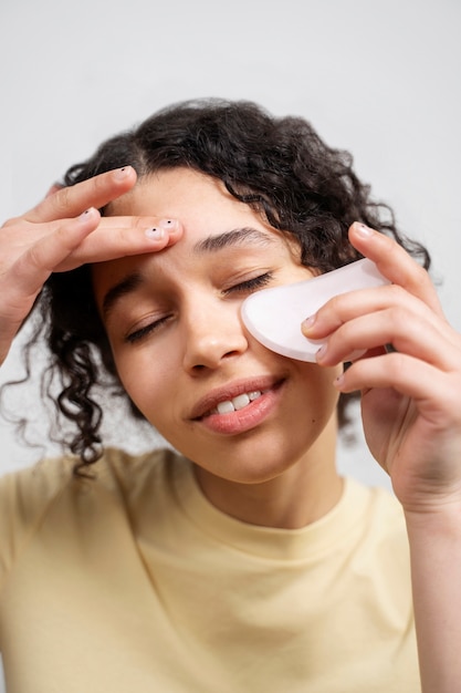 Young adult using face care product