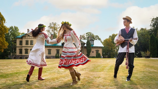 Free Photo young adults having fun while folk dancing