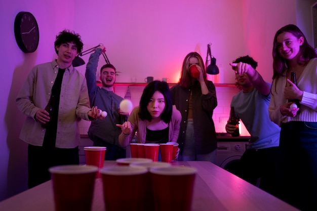 Free photo young adults playing beer pong