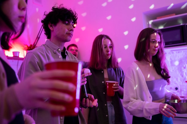 Young adults playing beer pong