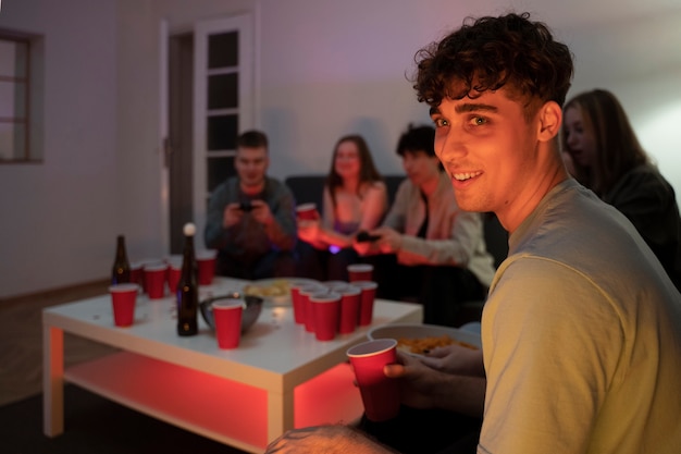 Free photo young adults playing beer pong