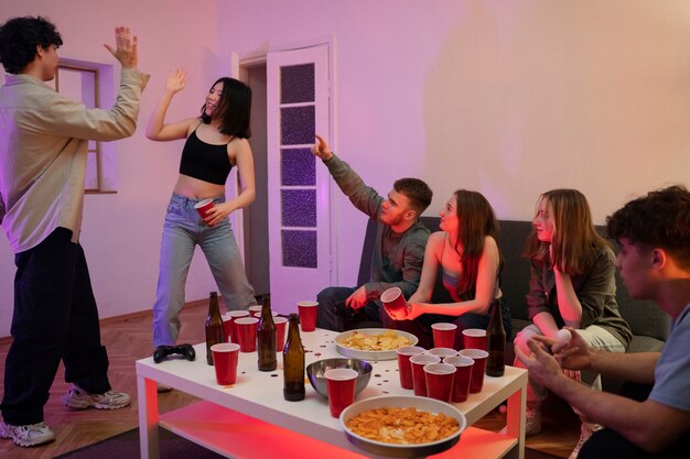 Young adults playing beer pong