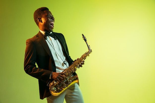 Young african-american jazz musician playing the saxophone