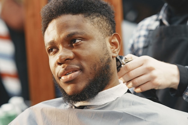 Young African-american man visiting barbershop