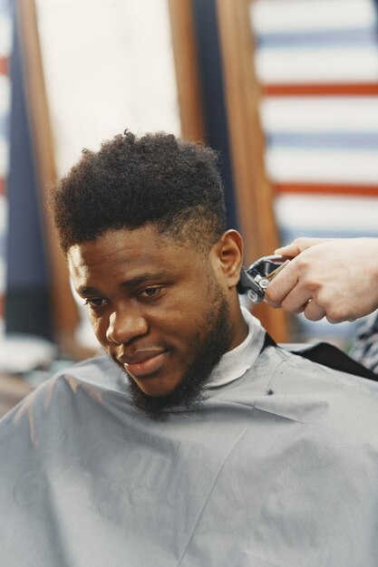 Young African-american man visiting barbershop