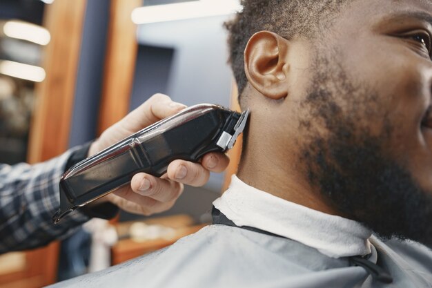 Young African-american man visiting barbershop