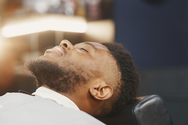 Young African-american man visiting barbershop