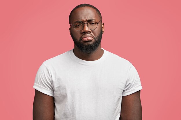 Young African-American man with round glasses