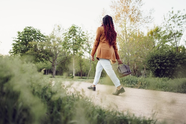 Free photo young african american woman having a walk in a park