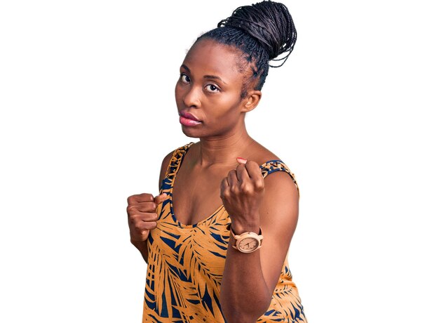 Young african american woman wearing casual clothes ready to fight with fist defense gesture, angry and upset face, afraid of problem