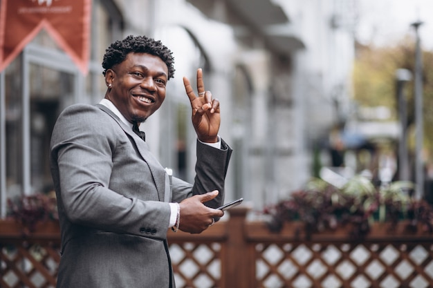 Young african businessman using phone