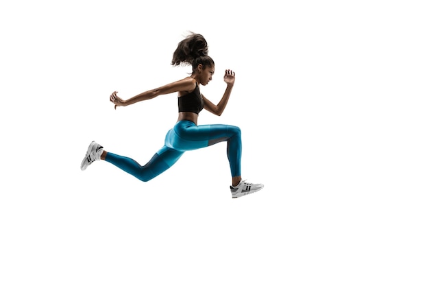 Young african woman running isolated on white studio background. One female runner or jogger. Silhouette of jogging athlete