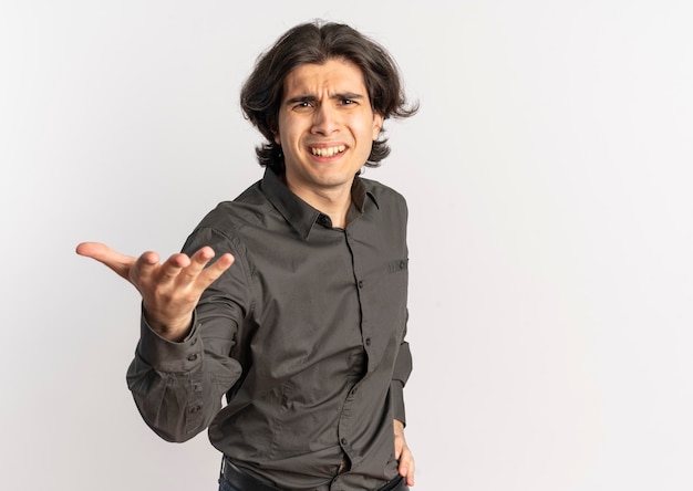 Young annoyed handsome caucasian man looks and points at camera isolated on white background with copy space