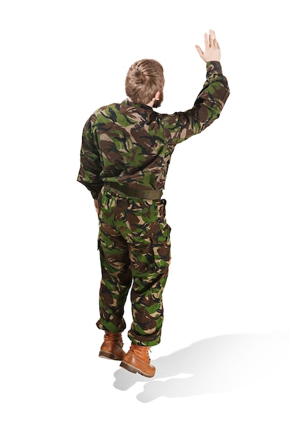 Young army soldier wearing camouflage uniform isolated on white