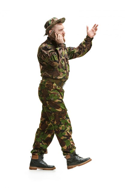 Young army soldier wearing camouflage uniform isolated