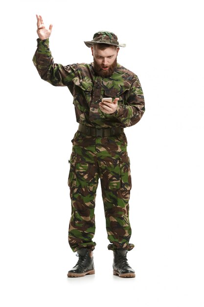 Young army soldier wearing camouflage uniform isolated