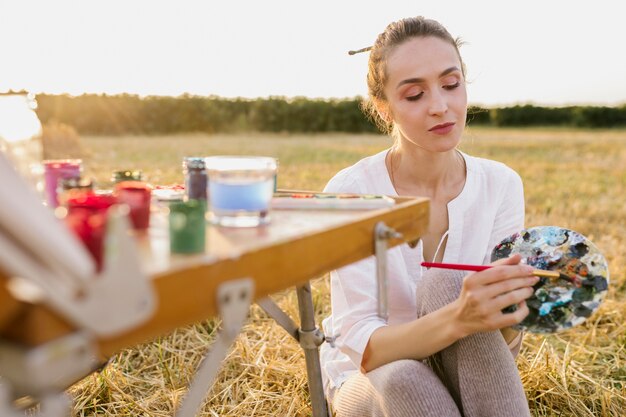 Young artist hand painting in the nature