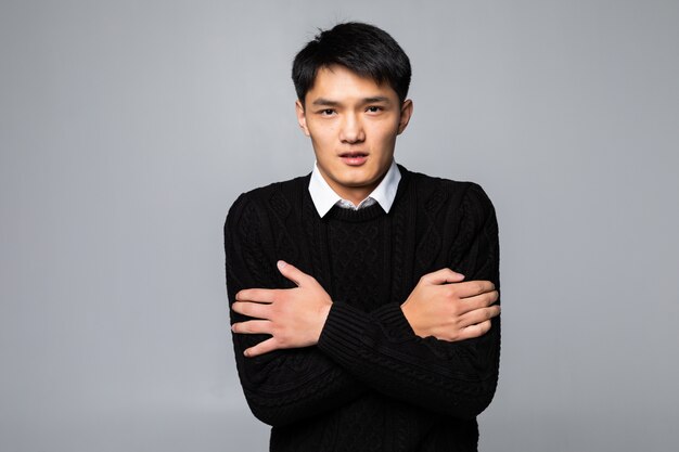 Young asian chinese man touching painful neck, sore throat for flu, clod and infection standing over isolated white wall