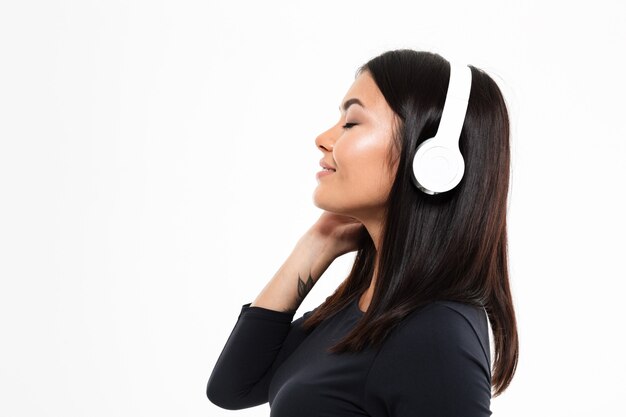 Young asian lady listening music with headphones