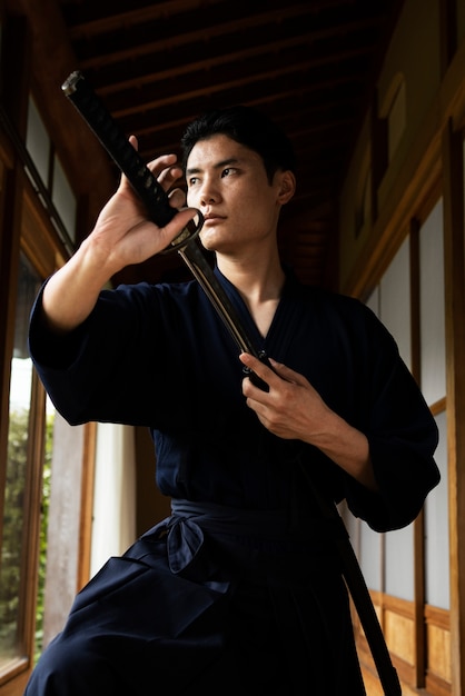 Free photo young asian man with samurai sword