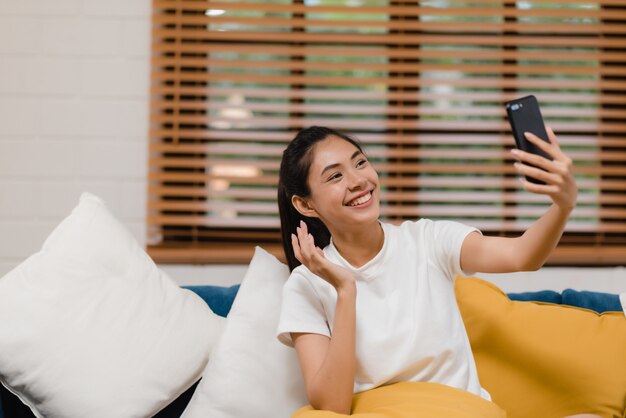 Young Asian teenager woman using smartphone video conference 