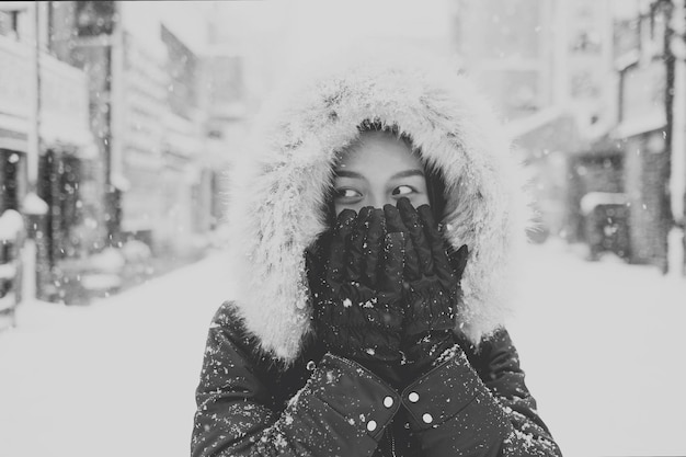 Free photo young asian tourist woman in winter sapporo japan black and white