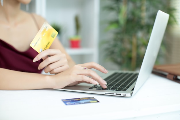 Young asian woman paying with credit card