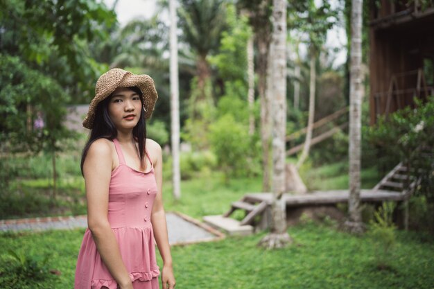 Young Asian woman relax in forest, Beautiful female happy using relax time in nature.