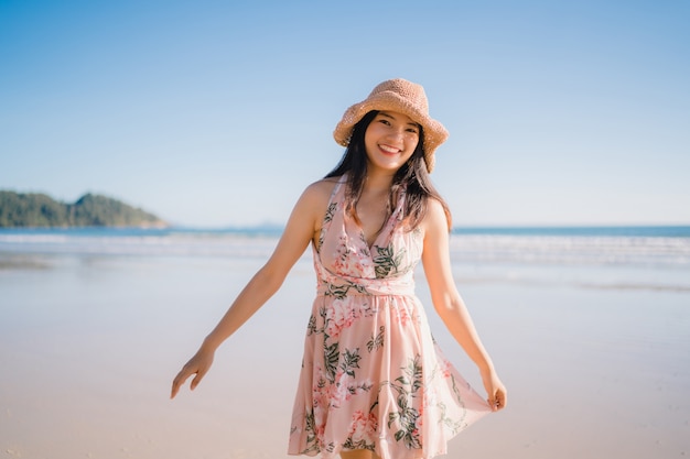 Young Asian woman walking on beach. Beautiful female happy relax walking on beach 