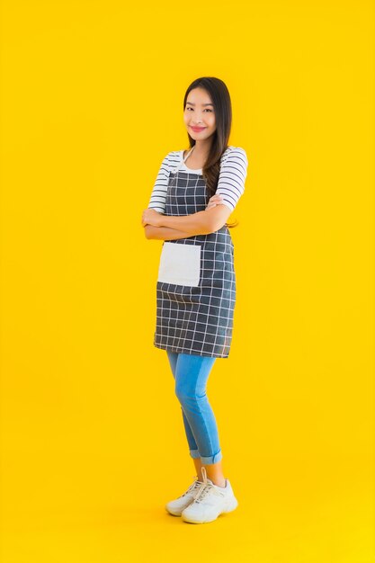 young asian woman wear apron with smile happy