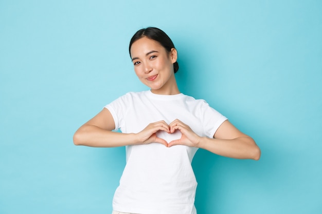 Young Asian woman wearing casual T-shirt posing