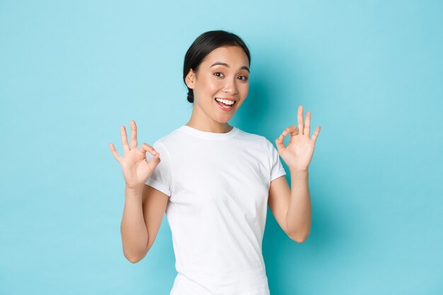 Young Asian woman wearing casual T-shirt posing