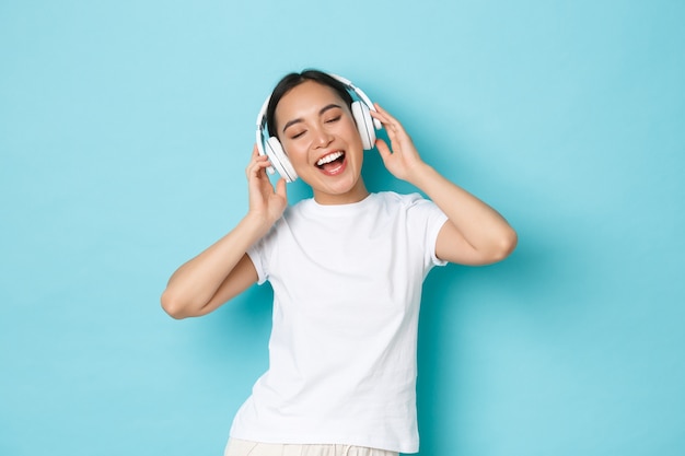 Young Asian woman wearing casual T-shirt posing