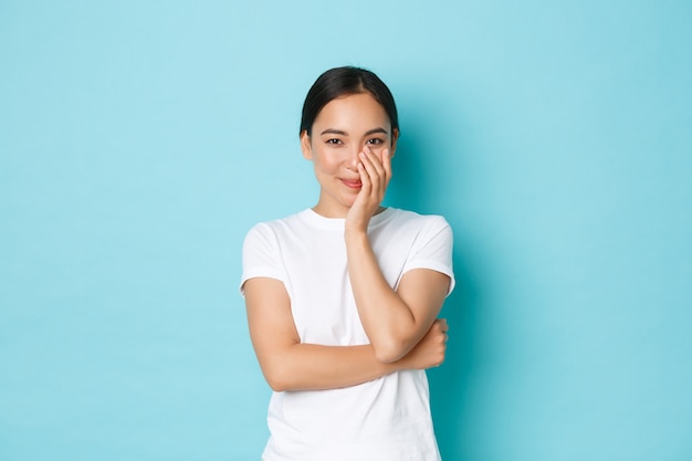 Young Asian woman wearing casual T-shirt posing