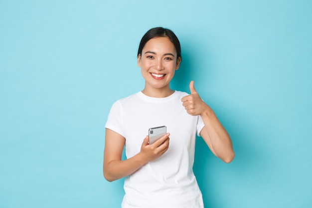 Young Asian woman wearing casual T-shirt posing