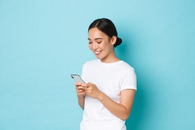 Young Asian woman wearing casual T-shirt posing