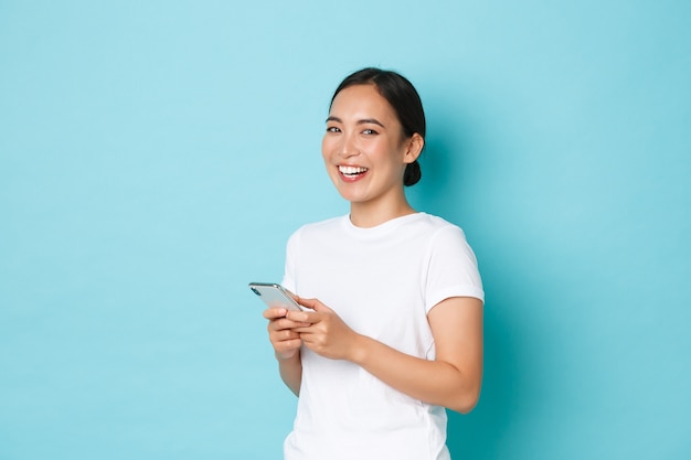 Young Asian woman wearing casual T-shirt posing