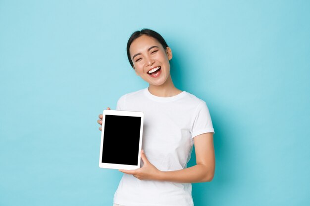 Young Asian woman wearing casual T-shirt posing