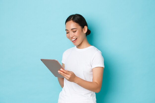 Young Asian woman wearing casual T-shirt posing