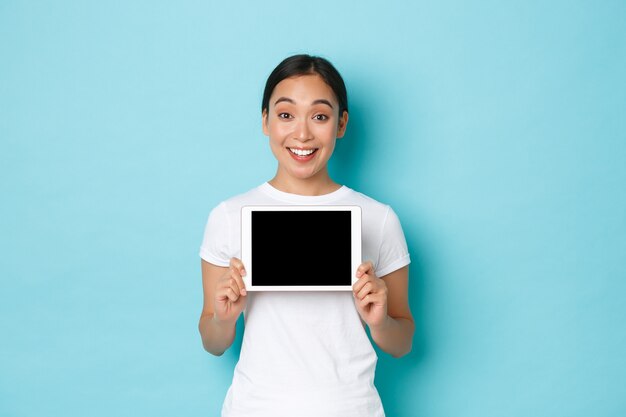 Young Asian woman wearing casual T-shirt posing