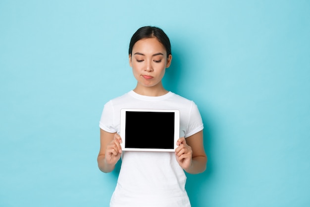 Young Asian woman wearing casual T-shirt posing