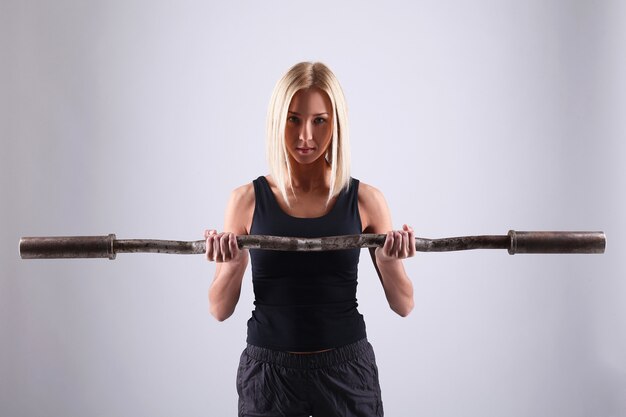 Young athlete woman with exercise bar