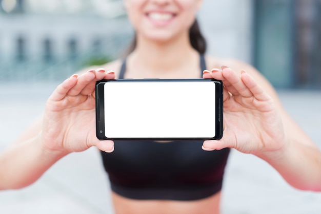 Young athlete woman with a smartphone