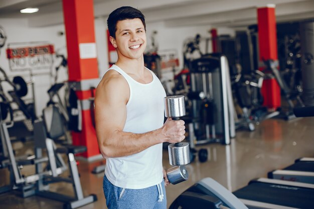 A young and athletic boy is engaged in sports in the gym